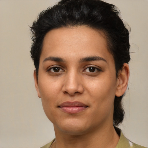 Joyful latino young-adult female with short  brown hair and brown eyes