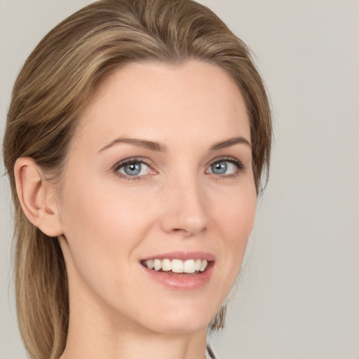 Joyful white young-adult female with medium  brown hair and grey eyes