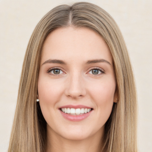 Joyful white young-adult female with long  brown hair and green eyes