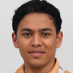 Joyful latino young-adult male with short  brown hair and brown eyes