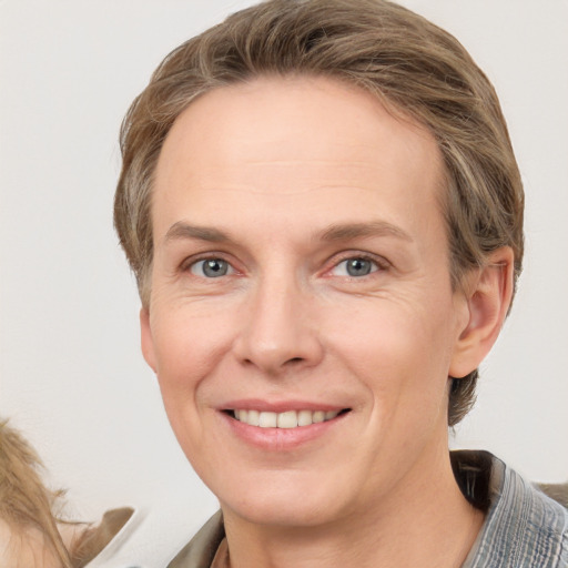 Joyful white adult female with short  brown hair and grey eyes