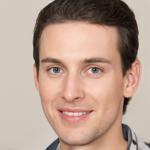 Joyful white young-adult male with short  brown hair and brown eyes