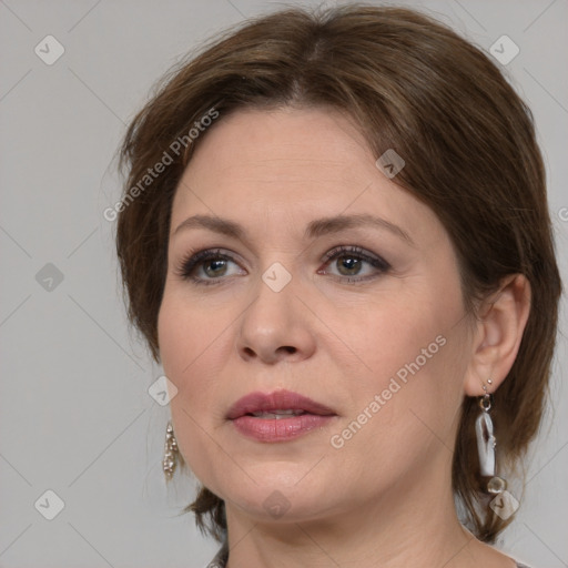 Joyful white adult female with medium  brown hair and grey eyes