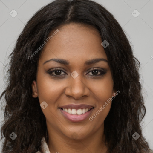 Joyful black young-adult female with long  brown hair and brown eyes