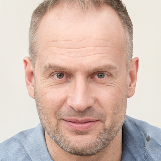 Joyful white adult male with short  brown hair and grey eyes