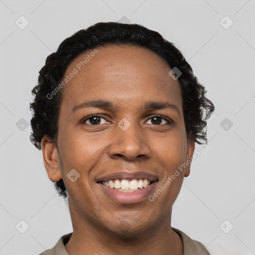 Joyful black young-adult male with short  black hair and brown eyes