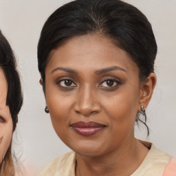 Joyful black young-adult female with medium  brown hair and brown eyes