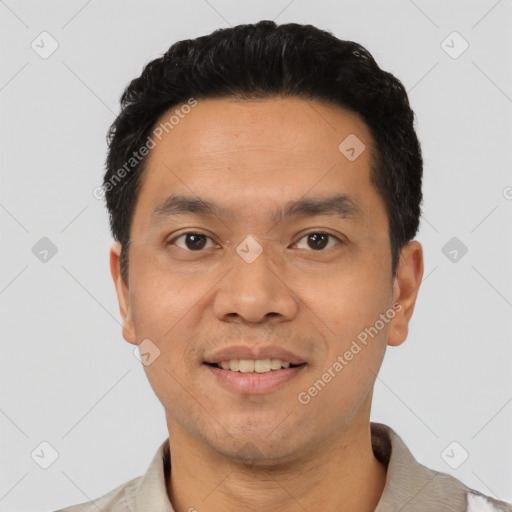 Joyful latino young-adult male with short  black hair and brown eyes