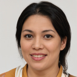 Joyful latino young-adult female with medium  brown hair and brown eyes