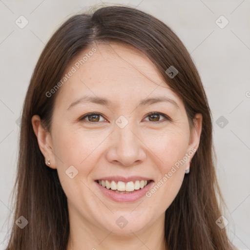 Joyful white adult female with long  brown hair and brown eyes