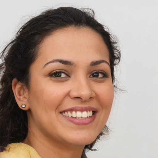 Joyful latino young-adult female with long  brown hair and brown eyes