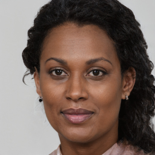 Joyful black adult female with medium  black hair and brown eyes