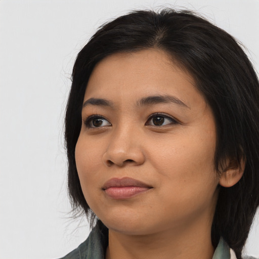 Joyful asian young-adult female with long  black hair and brown eyes