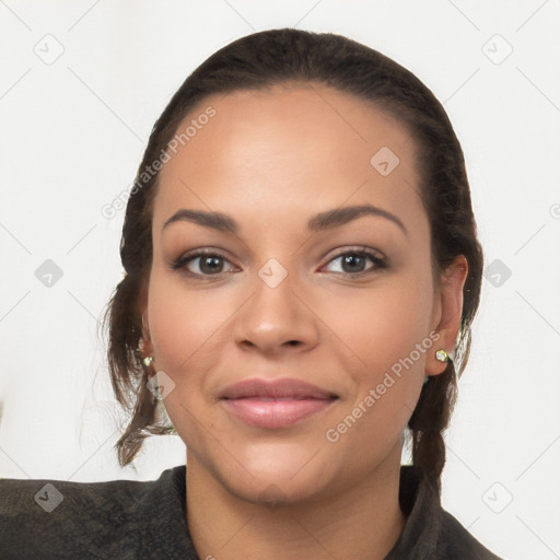 Joyful latino young-adult female with long  brown hair and brown eyes