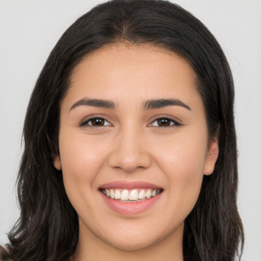 Joyful white young-adult female with long  brown hair and brown eyes