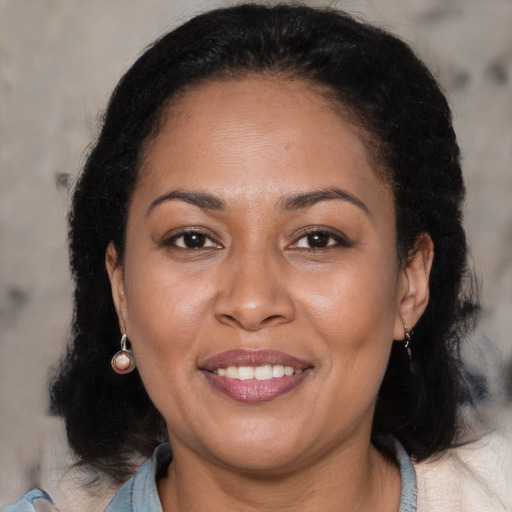 Joyful black adult female with medium  brown hair and brown eyes