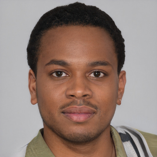 Joyful latino young-adult male with short  brown hair and brown eyes