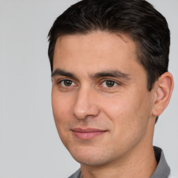 Joyful white adult male with short  brown hair and brown eyes