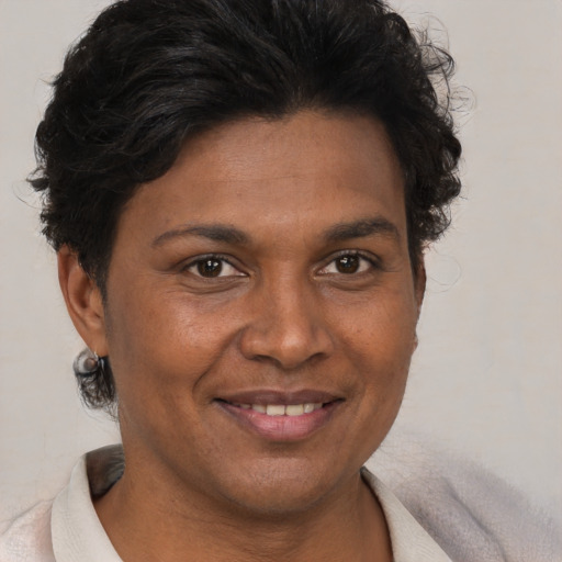 Joyful black adult female with short  brown hair and brown eyes