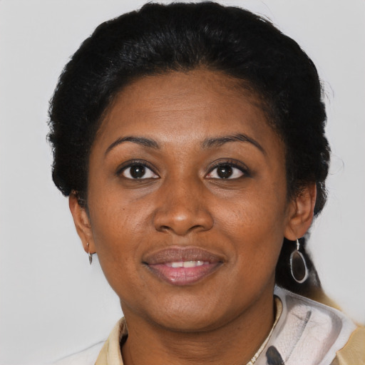 Joyful black adult female with short  brown hair and brown eyes