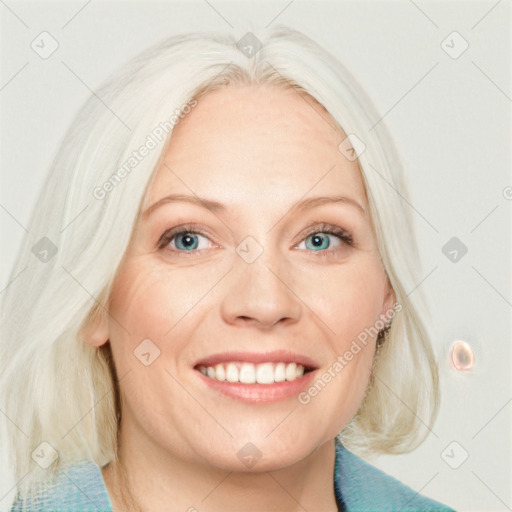 Joyful white adult female with medium  blond hair and blue eyes