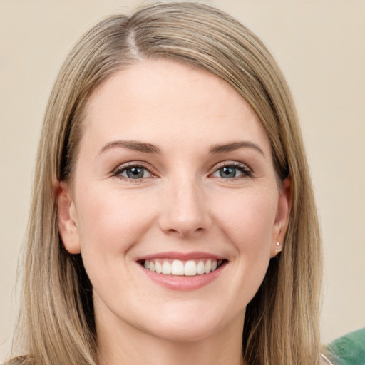 Joyful white young-adult female with long  brown hair and green eyes