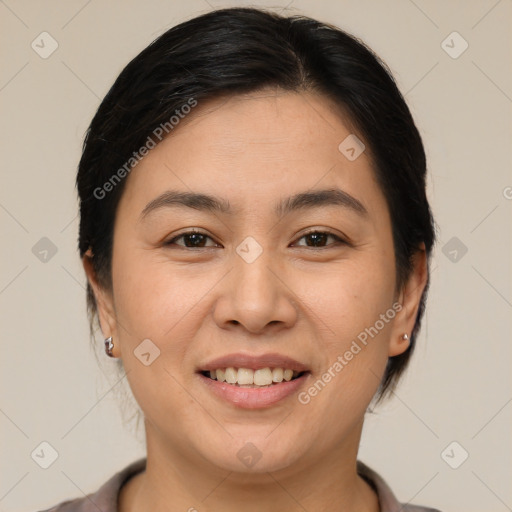 Joyful latino young-adult female with medium  brown hair and brown eyes