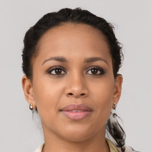 Joyful latino young-adult female with short  brown hair and brown eyes