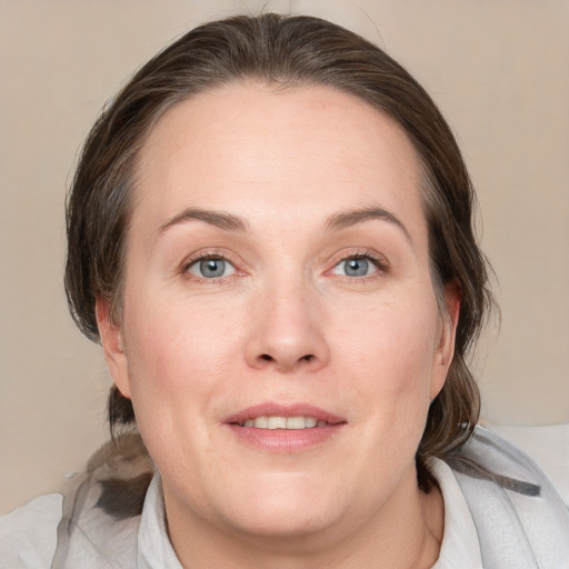 Joyful white adult female with medium  brown hair and grey eyes