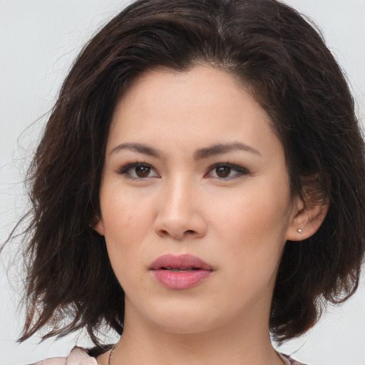 Joyful asian young-adult female with medium  brown hair and brown eyes