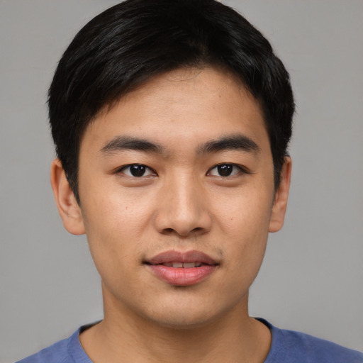 Joyful asian young-adult male with short  black hair and brown eyes