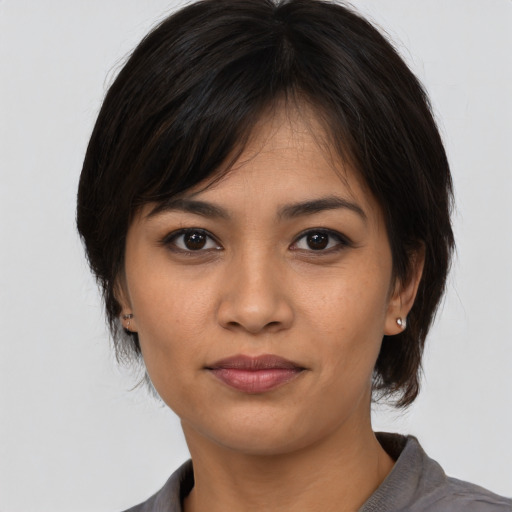 Joyful asian young-adult female with medium  brown hair and brown eyes
