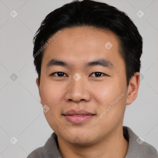 Joyful asian young-adult male with short  black hair and brown eyes