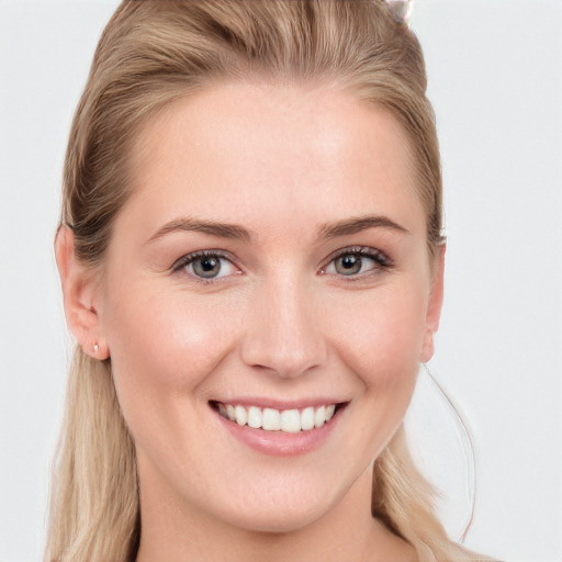 Joyful white young-adult female with long  brown hair and blue eyes