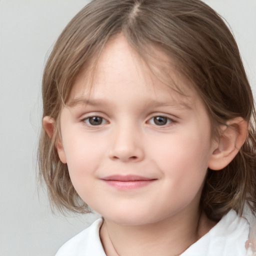 Joyful white child female with medium  brown hair and grey eyes