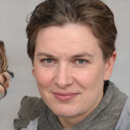 Joyful white adult female with medium  brown hair and blue eyes