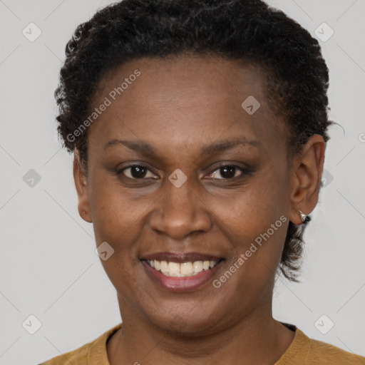 Joyful black adult female with short  brown hair and brown eyes