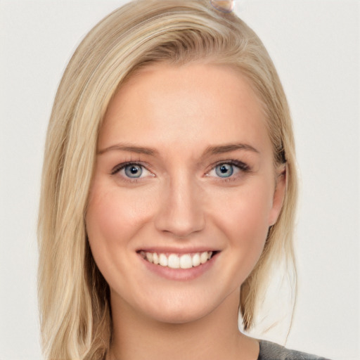 Joyful white young-adult female with long  brown hair and blue eyes