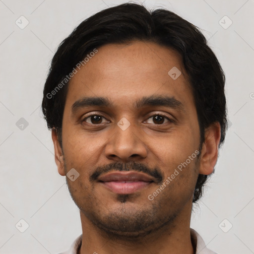 Joyful latino young-adult male with short  brown hair and brown eyes