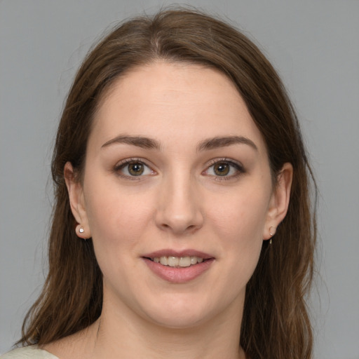 Joyful white young-adult female with medium  brown hair and green eyes