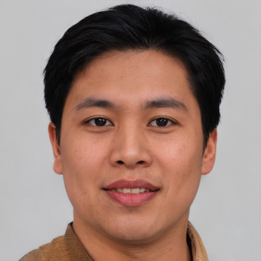 Joyful asian young-adult male with short  brown hair and brown eyes