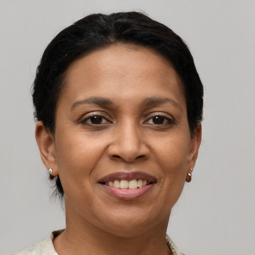 Joyful latino adult female with short  brown hair and brown eyes