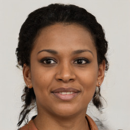 Joyful black young-adult female with short  brown hair and brown eyes