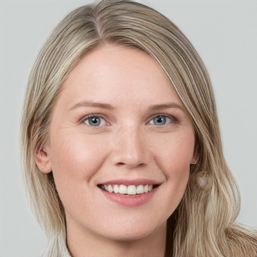 Joyful white young-adult female with long  brown hair and blue eyes