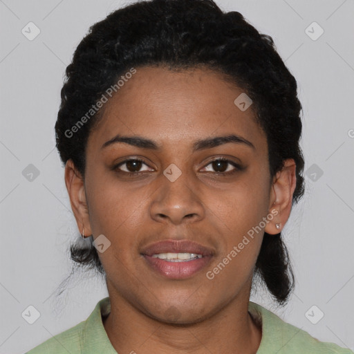 Joyful black young-adult female with short  black hair and brown eyes