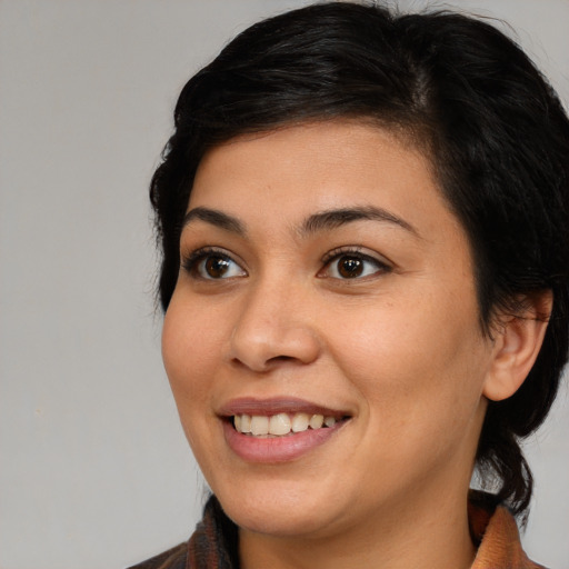 Joyful latino young-adult female with medium  brown hair and brown eyes