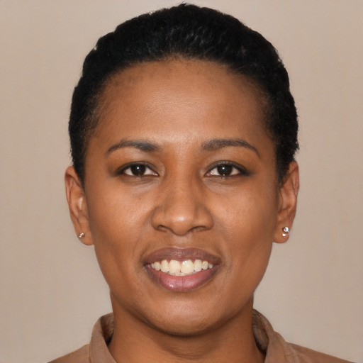 Joyful black young-adult female with short  black hair and brown eyes