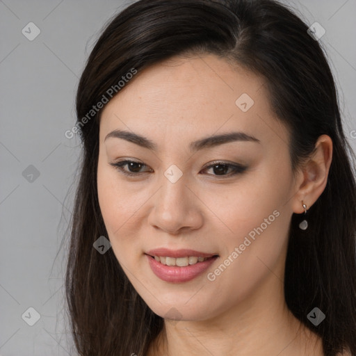 Joyful asian young-adult female with long  brown hair and brown eyes