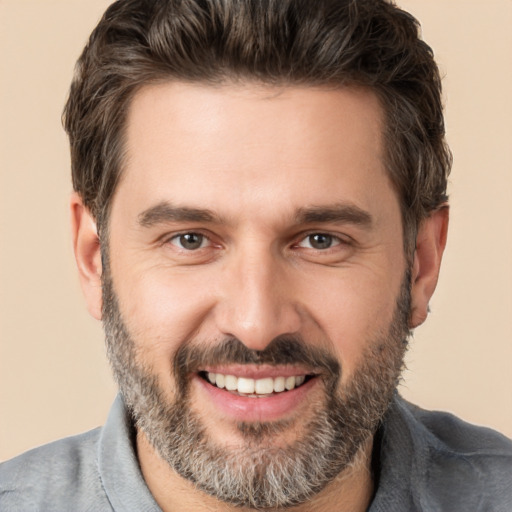 Joyful white adult male with short  brown hair and brown eyes