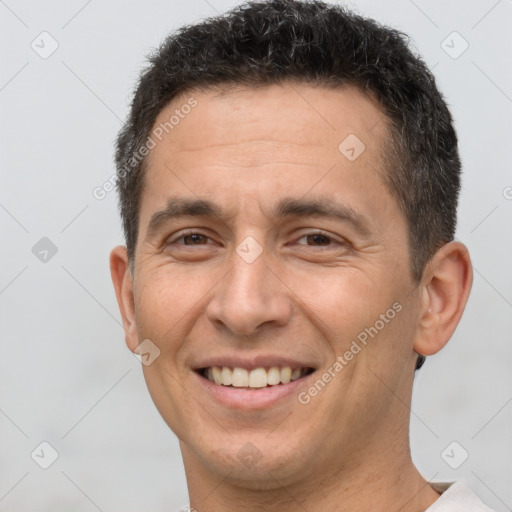 Joyful white adult male with short  brown hair and brown eyes